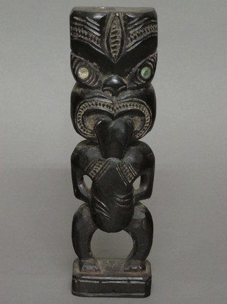 A carved Maori ebony figure 10"