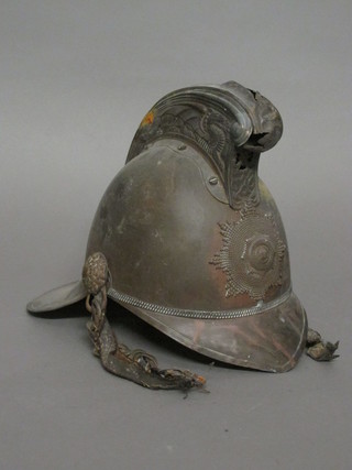 A 19th/20th Century brass National Fire Brigade Association Fireman's helmet, some damage,  ILLUSTRATED