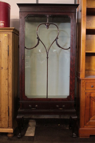 A 1930's mahogany Chippendale style display cabinet, the shelved interior enclosed by astragal glazed doors, the base fitted  1 long drawer and raised on cabriole supports 30"