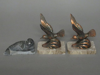 An Eskimo carved figure of a reclining sea lion 3" and 2 Art  Deco spelter figures of doves, raised on marble bases
