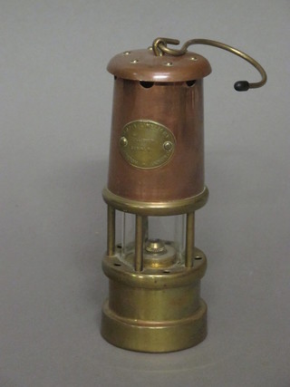 A reproduction copper and brass miner's safety lamp 7"