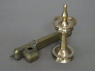 A Persian brass quill case incorporating an inkwell together with  a brass candlestick 7 1/2"