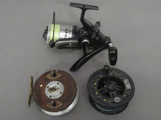 An aluminium mahogany centre pin fishing reel 3" together with  a Zebco 740 multiplying fishing reel