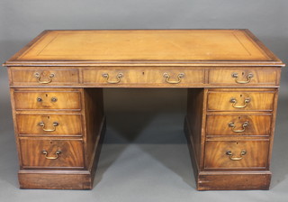 A mahogany desk with inset writing surface above 1 long and 8 short drawers, 57"