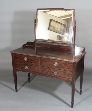 An Edwardian mahogany dressing table with rectangular bevelled plate mirror above 2 short and 1 long drawer, raised on square  tapering supports ending in spade feet 45"