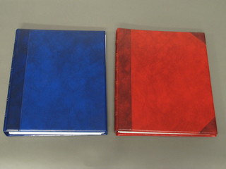 A blue ring bind folder and an orange do. containing postcards - mainly views