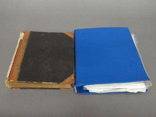 A blue loose leaf album of stamps and a brown stock books of  stamps