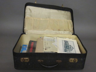 A suitcase containing a collection of ephemera