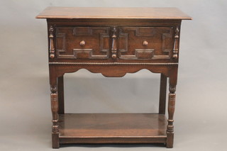 A carved oak dresser base fitted 2 long drawers above a pot cupboard, raised on turned and block supports 36"