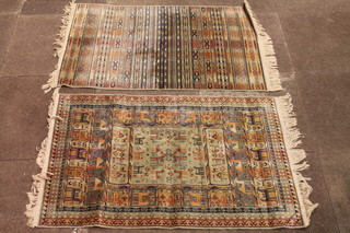 4 similar machine made Persian style rugs 42" x 28"