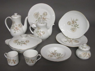 A 125 piece Royal Doulton Yorkshire Rose pattern dinner/tea service comprising 3 circular twin handled tureens and stands 8  1/2", an oval meat plate 13 1/2", 8 dinner plates 10", 10  side plates 8" - 1 a second, 3 soup bowls 8" - 2 seconds, 27 tea  plates 6 1/2" - 2 seconds, 6 bowls 7", sauce boat and stand, 2  twin handled bread plates 9", 7 bowls 5", 18 saucers 6", 9 cups,  6 coffee cans and 6 saucers, sugar bowl 3 1/2", sandwich plate  10", large teapot 7", coffee pot, small teapot 6", teapot 4", 2  jugs 5", jug 4", 2 lidded sugar bowls 3"