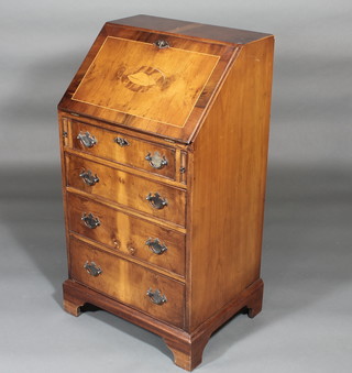 A Georgian style yew bureau, the fall front revealing a well fitted interior above 4 long drawers, raised on bracket feet 20"
