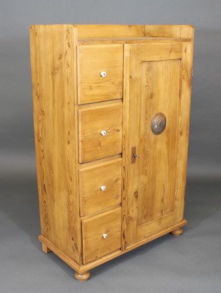 A stripped and polished pine combination wardrobe the top with three-quarter gallery, fitted 4 shelves and having a cupboard to  the side enclosed by a panelled door 34"