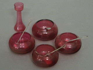 4 cranberry glass salts and 4 silver plated salt spoons
