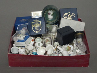 A collection of thimbles contained beneath 2 perspex domes
