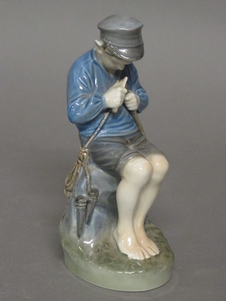 A Royal Copenhagen figure of a seated boy whittling, base  marked 905 7"