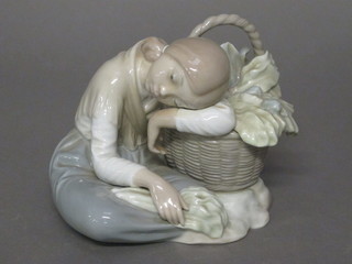 A Lladro figure of a kneeling child with basket of fruit 5"