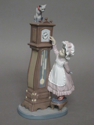 A Lladro figure of a girl with a longcase clock 10"