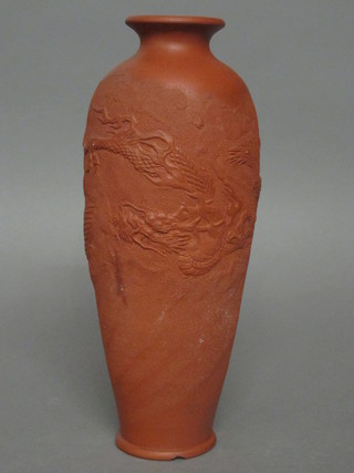 An Oriental terracotta vase decorated a dragon, the base with 2 character mark 12", chip to base,