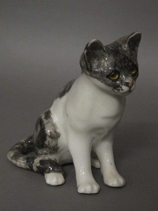 A pottery figure of a seated cat with glass eyes 9"
