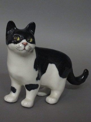 A black and white figure of a standing cat with glass eyes 8"