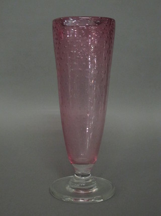 A pink bubble glass vase raised on a spreading foot 14"