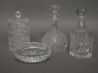 A cut glass spirit decanter, a club shaped decanter, a cylindrical biscuit barrel and cover together with an ashtray