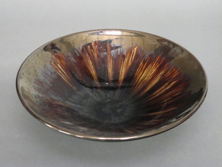A circular brown lustre pottery dish 13"