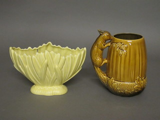 A blue glazed Sylvac jug in the form of an acorn the handle  decorated a squirrel and a yellow glazed boat shaped vase