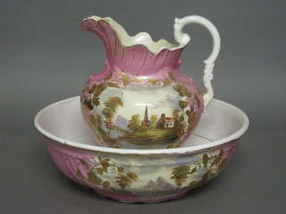 A pink and gold glazed pottery jug and bowl set, both cracked,