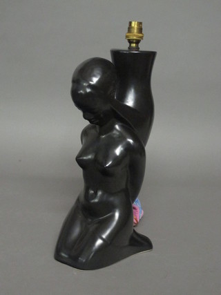A black glazed pottery table lamp in the form of a kneeling naked lady  15"