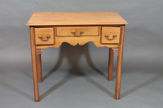 A 19th Century bleached mahogany side table, fitted 1 long and 2 short drawers, raised on square tapering supports 32"