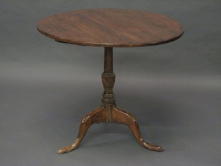 A 19th Century circular mahogany snap top tea table, raised on  pillar and tripod supports 32"