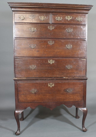 A Georgian oak chest on stand, the moulded cornice fitted a  secret drawer above 2 long and 3 short drawers, the base fitted 1  long drawer with brass swan neck handles, raised on cabriole  supports 43"  ILLUSTRATED