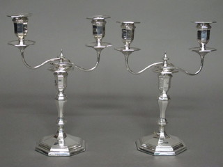 A pair of Victorian silver twin light candelabrum with detachable  sconces, raised on octagonal bases, Sheffield 1892, 11"   ILLUSTRATED