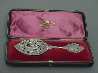 A pierced Continental white metal spoon, cased