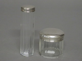 A Victorian cylindrical cut glass dressing table jar with silver lid, London 1885 together with a glass pin jar with silver lid