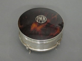 An Art Deco circular silver and tortoiseshell dressing table jar  with hinged lid, raised on hoof feet, marks rubbed 4"