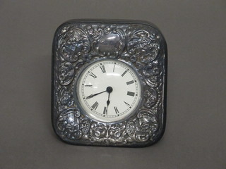A modern battery operated bedroom timepiece contained in an  embossed silver case, 3"