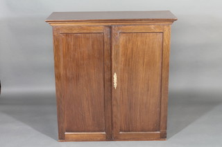 A 19th Century mahogany cabinet with shelved interior enclosed  by a panelled door 39"