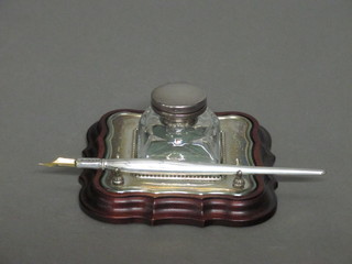 A cut glass inkwell with silver lid and mounts together with a  silver dip pen, Sheffield with millennium hallmark