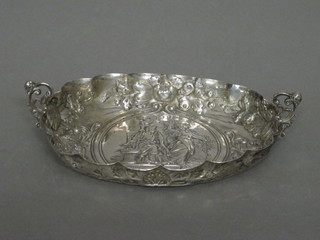 An oval embossed white metal twin handled dish   ILLUSTRATED