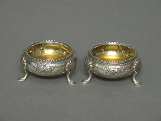 A pair of Victorian circular silver salts, raised on hoof feet, Sheffield 1877, 3 ozs