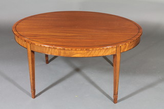 A Georgian style oval inlaid mahogany coffee table, raised on  square tapering supports ending in spade feet 37"