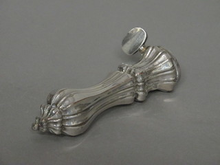 A silver plated ham bone clamp