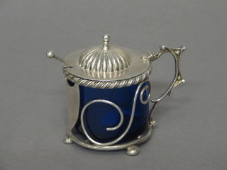 A handsome silver plated mustard pot with blue glass liner