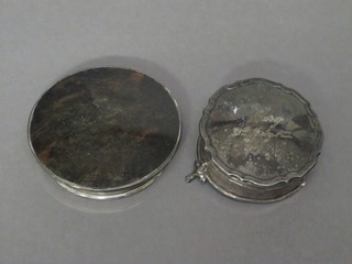 A circular silver trinket box with hinged lid, raised on 3 hoof feet, 2", marks rubbed, together with a tortoiseshell and silver  mounted dressing table jar lid Birmingham 1923, 2 1/2"