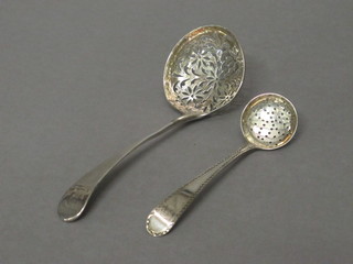A Georgian silver Old English pattern sifter spoon with bright cut decoration, London 1781 and a Georgian Old English silver sifter  spoon London 1810, 2 ozs
