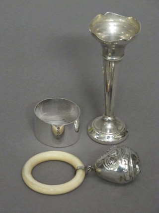 A modern silver rattle in the form of Humpty Dumpty with  teething ring together with a modern silver specimen vase 4 1/2"  and a silver plated napkin ring
