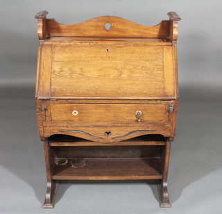An oak Art Nouveau student's bureau with three-quarter gallery, the fall front revealing a fitted interior above 1 long drawer 29"